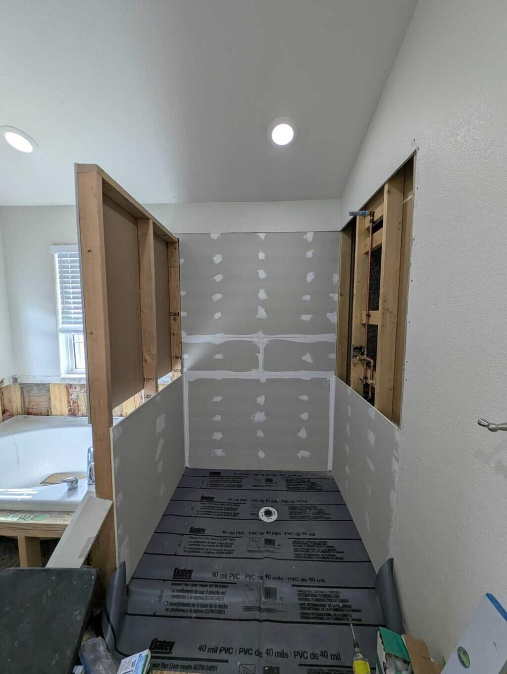 Shower pan partly done and walls partly installed