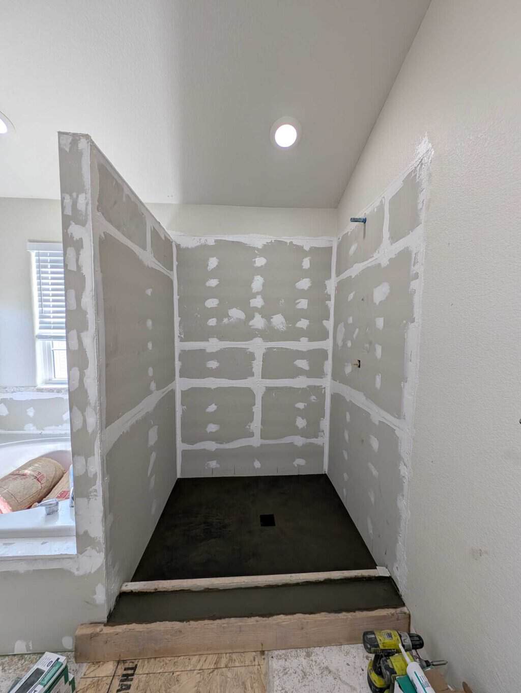 Finished shower pan and wall underlayment/sealant