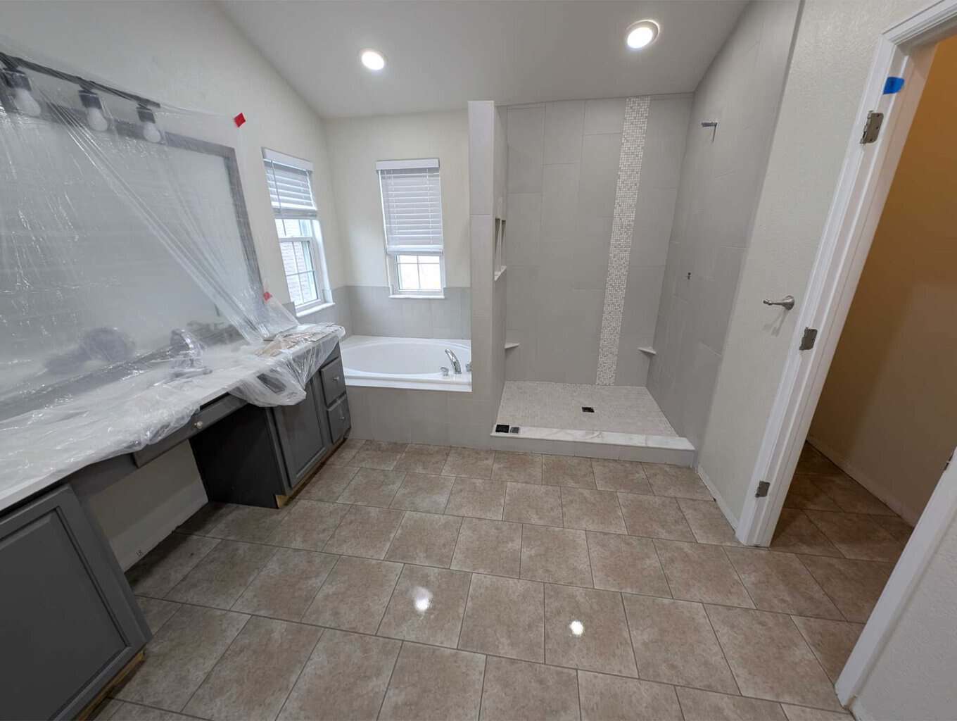 Primary bath floor, shower, and tub finished