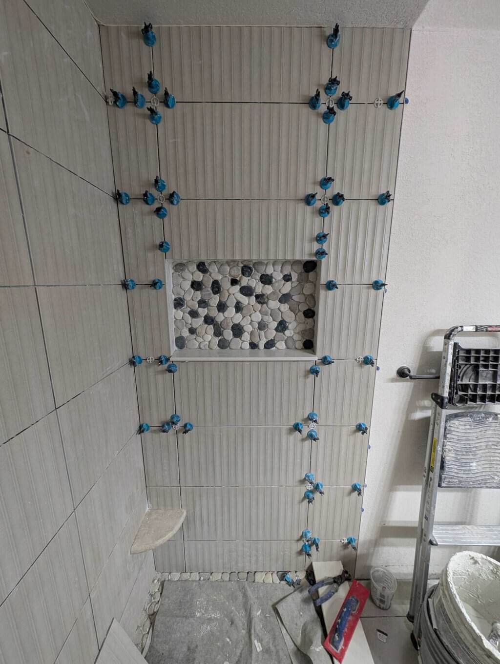 Accent tiled in back of niche and field tile to ceiling