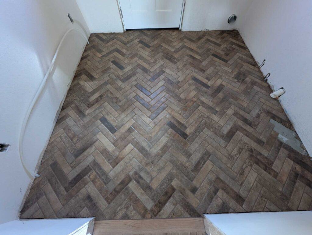 Laundry herringbone floor grouted and finished