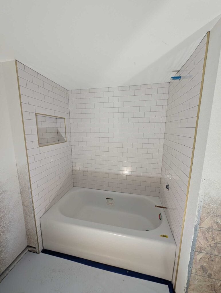 Basement tub surround grouted and finished