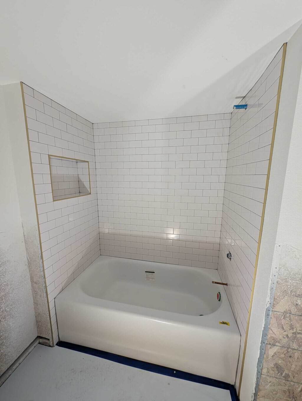 Basement tub surround grouted and finished