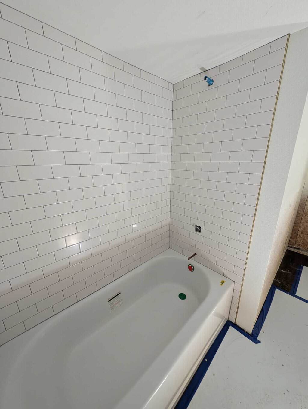 Basement tub surround grouted and finished