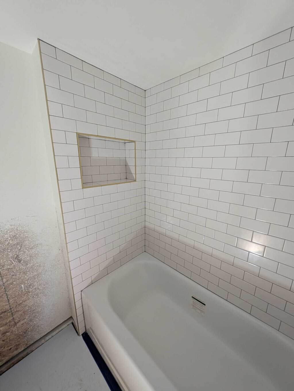 Basement tub surround grouted and finished