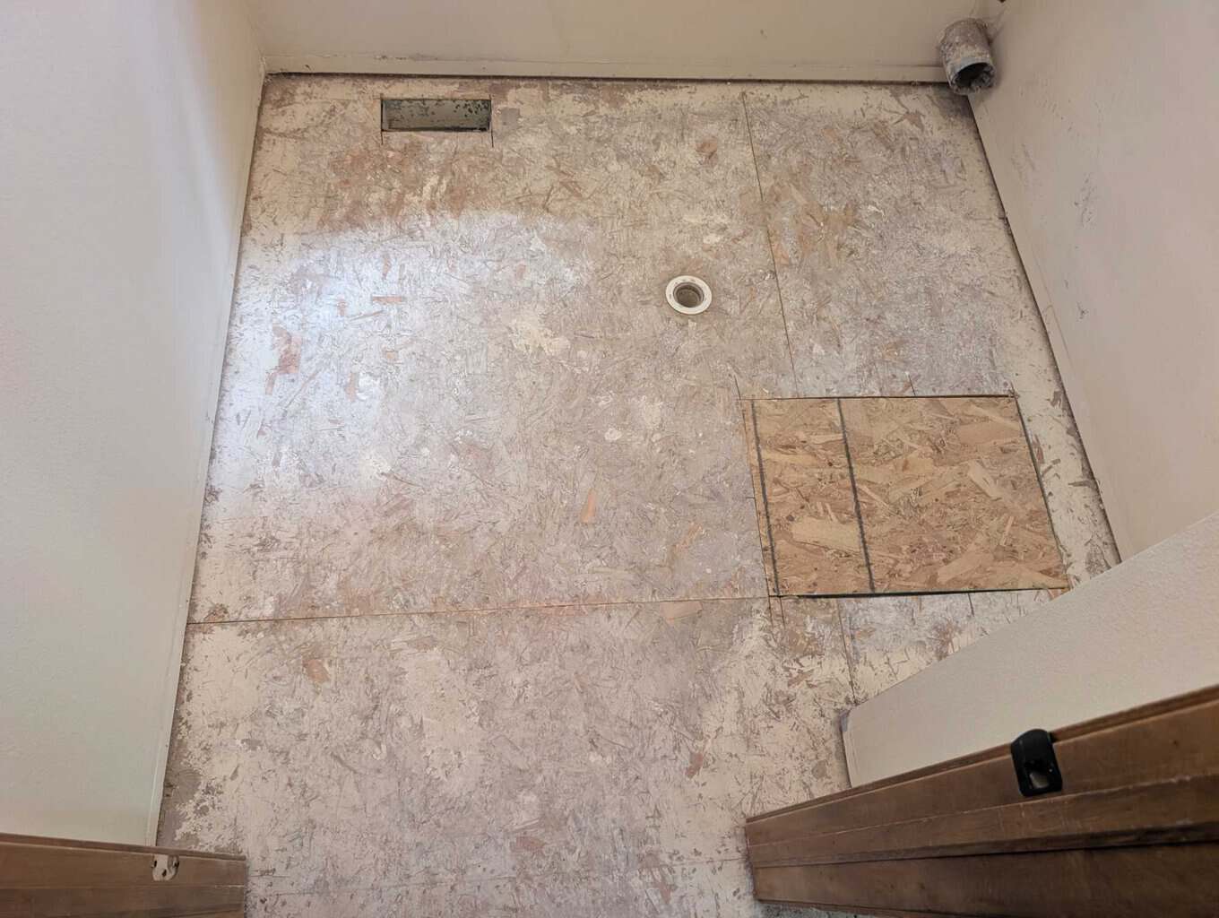 Floor patched, baseboards removed, staples sunk